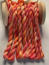 Load image into Gallery viewer, Sunset hand dyed threads in soft, muted colors right bold colors of red, orange yellow and maybe a hint of pink
