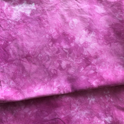 Hand dyed cotton in a mottled, reddish purple.