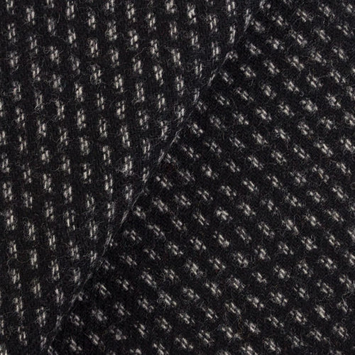Wool fabric with black background and a white double running stitch woven into in in stripes