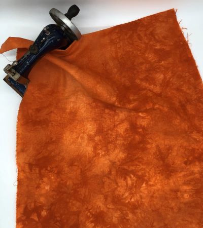 Medium orange mottled hand dyed linen.