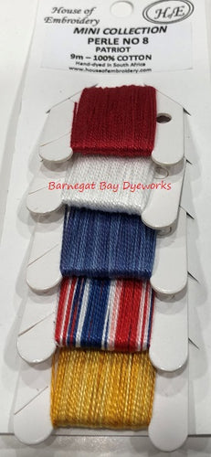 Five colors of #8 Perle Cotton hand dyed thread in red, white, blue variegated, red, white and blue variegated and gold variegated.