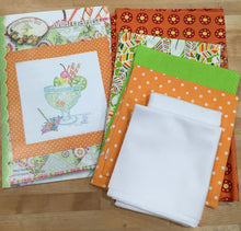 Load image into Gallery viewer, Pattern Cover and the fabrics in our Margarita kit - bright oranges, green and white 
