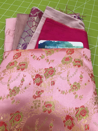 Crazy Quilt Pinks has a main fabric of pink & gold roses, with dk and light pinks, purple pink, dusty pinks as coordinates