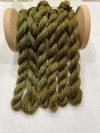 Dark Olive hand dyed variegated wool threads in a mix of yellow and blue greens.