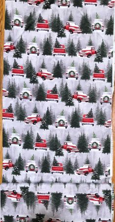 Henry Glass Fabrics with vntage red trucks on a snowy background