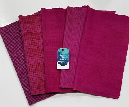 Five pieces of hand dyed wool fabric all from the same dyebath in 4 textures and a solid of a deep reddish pink with a purple undertone.