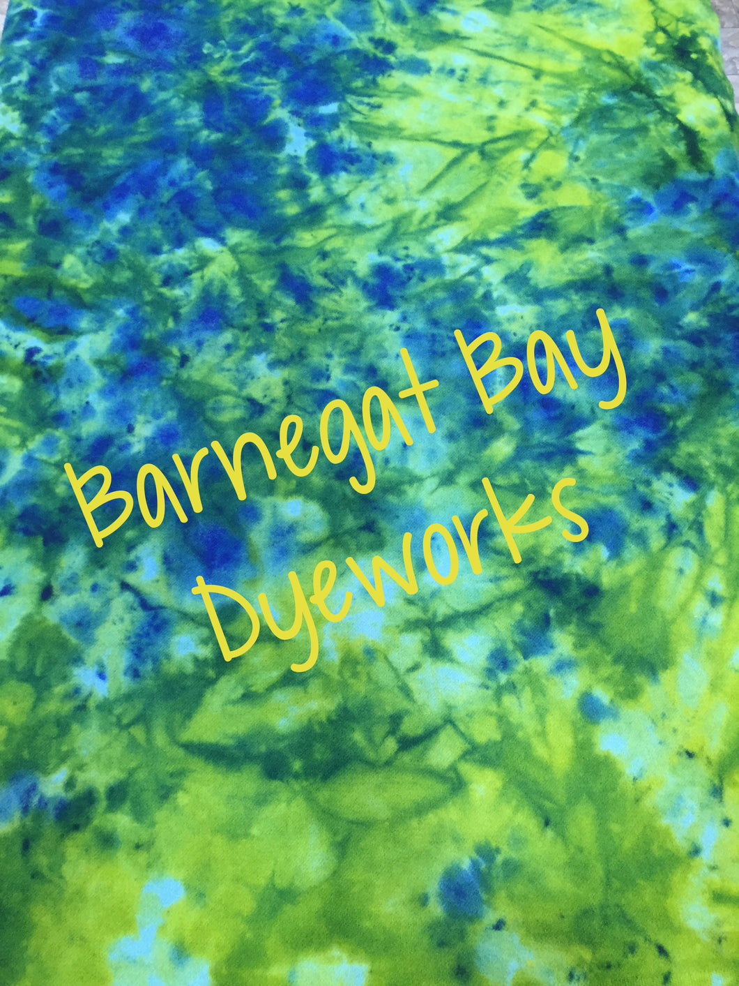 100% wool with a tie dyed look of blues, greens and yellows.