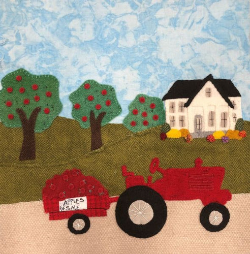Wool on cotton applique block kit or pattern of a vintage tractor, farmhouse and apple orchard. Details added with embroidery stitches