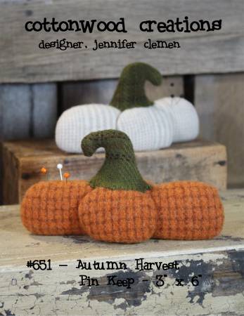 Squat stuffed pumpkin made from wool.