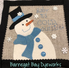 Load image into Gallery viewer, Wool Applique 8&quot; square with a white snowman with a black hat, blue scarf, buttons and hat band and an orange button nose on a oatmeal colored wool background and snowflake buttons.  Stitched wording says Baby It&#39;s Cold Outside! Kit Who knows the weather better than a snowman? A cute 8x8&quot; 
