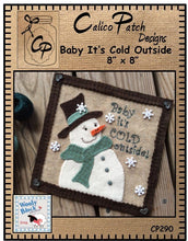 Load image into Gallery viewer, Pattern cover for an 8&quot; square of a snowman in a scarf and hat with buttons down the front on a tan background with snowflake buttons and stitched words Baby It&#39;s Cold Outside.
