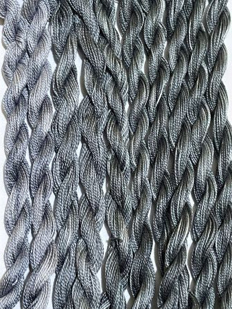 Hand dyed black and grays #12 pearl cotton threads.