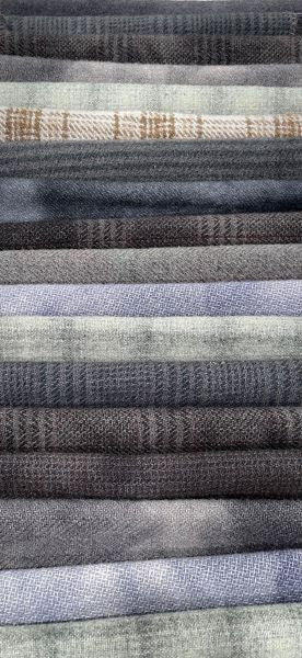 A vertical stack of black and gray hand dyed wools