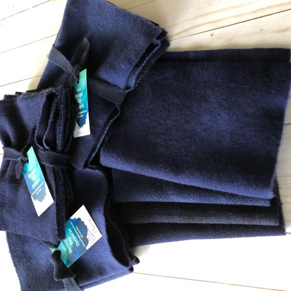 Four pieces of hand dyed wool in a mottled navy color.
