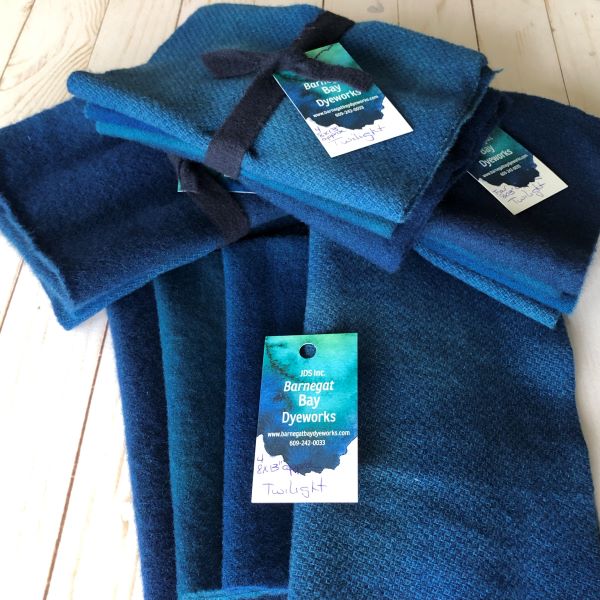 Four shades of the a hand dyed medium blue wool with a hint of teal, on three textures and a solid wool.