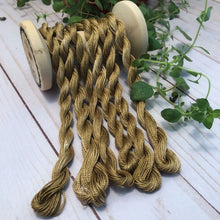 Load image into Gallery viewer, Hand Dyed Bronze pearl cotton #8 and #12 thread draped over a vintage thread spool.
