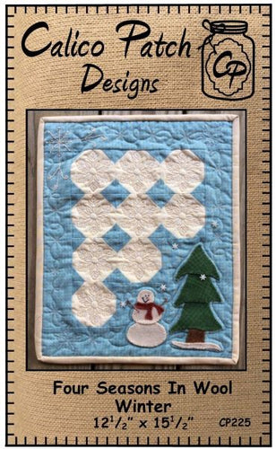 Four Seasons In Wool Winter Pattern by Calico Patch Designswith blue background, white snowball black with a wool applique snowman and a evergreen tree in the bottom left hand corner.