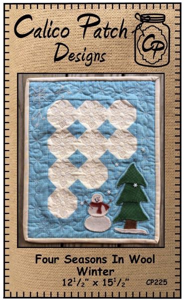 Four Seasons In Wool Winter Pattern by Calico Patch Designswith blue background, white snowball black with a wool applique snowman and a evergreen tree in the bottom left hand corner.