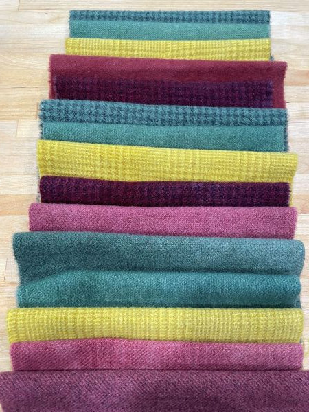 3 wool bundles showing Christmas Primitivies - two greens, two reds and one gold in primitive colors