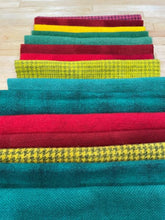 Load image into Gallery viewer, 3 wool bundles showing Christmas Brights  - two greens, two reds and one gold in bright colors
