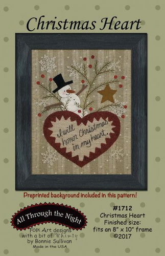 Pattern cover showing a framed wool appllique snowman, star, and heart with 