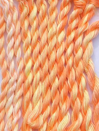 Hand painted yellow and orange 6 strand embroidery floss, #12 and #8 Pearl Cotton threads in the colors of a Creamsicle ice cream