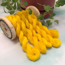 Load image into Gallery viewer, Five skeins of hand dyed wool thread in a bight happy daffodil yellow draped over a vintage thread spool.
