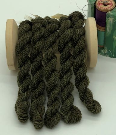 hand dyed #8 wool thread is a variegated, medium dark green with a hint of yellow - think leaves, pine trees, dark grass, shading other yellow greens and more