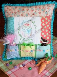 Spring themed pillow pattern has a center to hand embroider, borders and three pockets along the bottom of the pillow to fill with goodies.