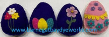Load image into Gallery viewer, Hand dyed, die cut, wool eggs in spring colors decorated with die cut flowers and hand stitching and wool applique.
