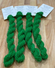 Load image into Gallery viewer, Skeins of hand dyed wool thread in a medium dark green with a hint of yellow
