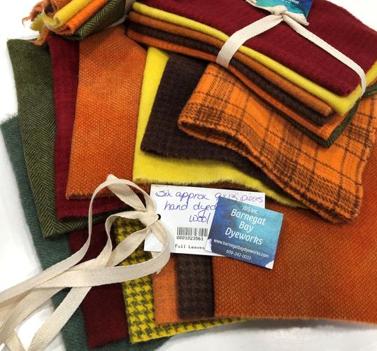 Seven hand dyed wool pieces for applique with two greens, two oranges, a yellow, a red, a green and a brown