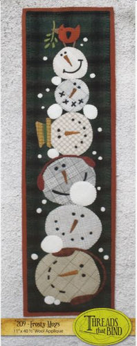 Six wool applique snowman heads with different expressions stacked willy nillyi in a tall stack and a cardinal on top by Threads That Bind.