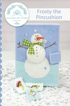 Pattern cover for needle book with a wool applique snowman on the front and a pincushion inside.