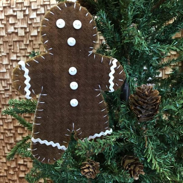 Wool gingerbreadman ornament with brown houndstooth wool, tiny rick rack for icing and hanger and white buttons for eyes, mouth and buttons