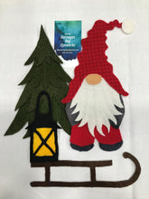 Load image into Gallery viewer, Pillow or Wall hanging of a gnome standing by a Christmas tree with a lantern on an old fashioned sled with a white background.
