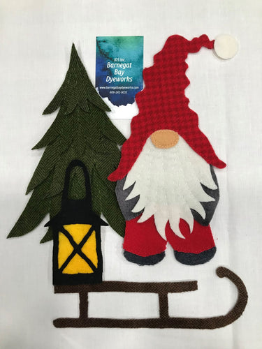 Pillow or Wall hanging of a gnome standing by a Christmas tree with a lantern on an old fashioned sled with a white background.