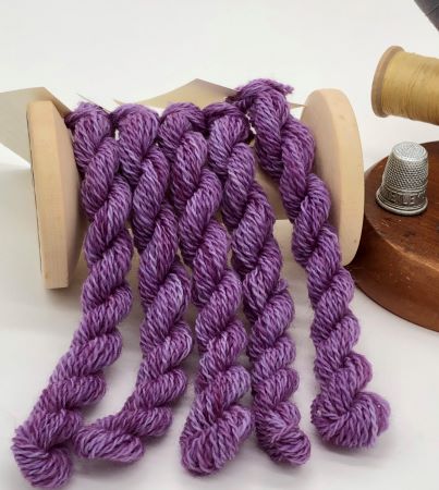 Five skeins of hand dyed wool thread is a variegated, dark medium purple in the red purple family.  Perfect for wool applique.