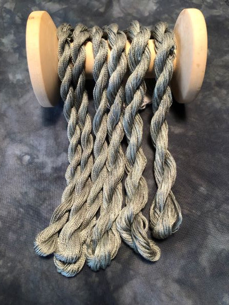 Gray hand dyed threads with a slight green tint.
