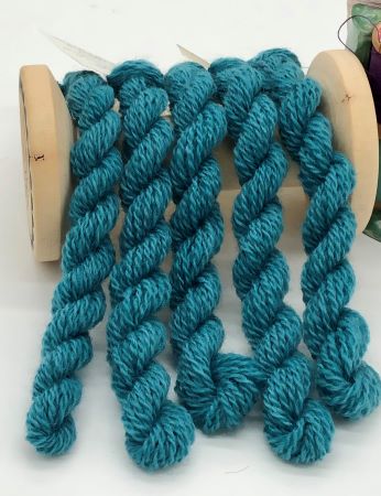 Five skeins of hand dyed #8 wool thread in bottle green - a blueish green.