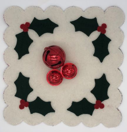 Pre-cut square wool applique mat with holly leaves and berries.