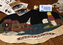 Load image into Gallery viewer, Wool applique lighthouse stands watch over coastal pier in an oval mat by Crane Designs.
