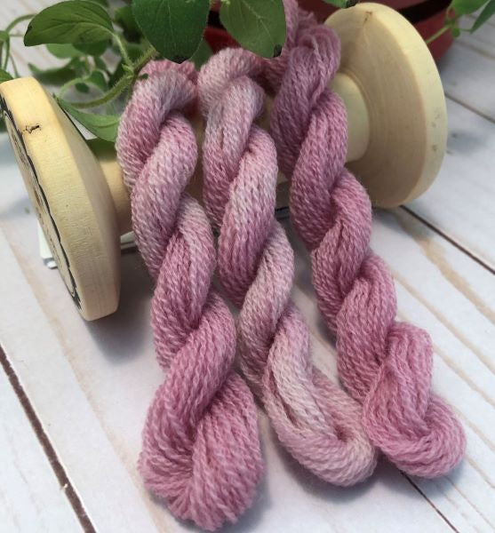 Skeins of hand dyed light violet variegated thread.