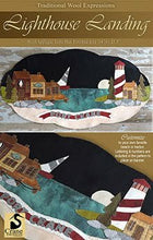 Load image into Gallery viewer, Wool applique pattern cover for Lighthouse Landing with a lighthouse standing watch over a coastal town.
