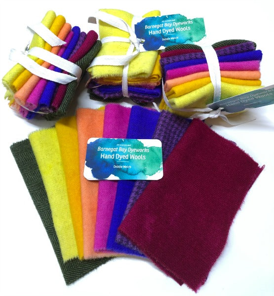 Bundles of hand dyed, felted, 100% wool in bright colors of pansies - dark green, yellow, gold, paler orange, purple, blue, dark purple and a dark red for wool applique.
