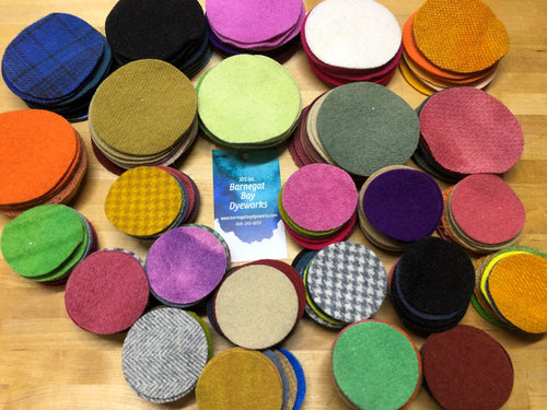 Stack of wool pennies in different colors and sizes.