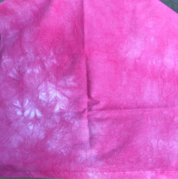 Hand dyed cotton fabric, mottled in a dark pink.