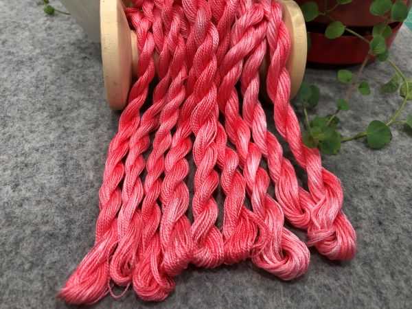 Hand dyed threads in a reddish pink color.  Available in 6 strand embroidery floss, #12 and #8 pearl cottons.