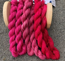 Load image into Gallery viewer, Three of our hand dyed darker pink wool threads .  From left to right Raspberry Sherbert, Morning Rose and Dark Pink.
