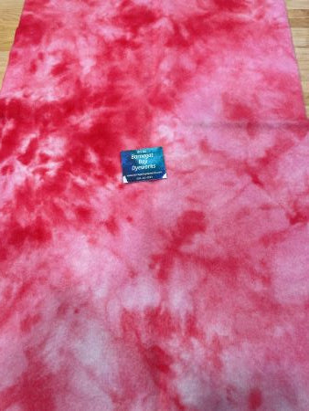 Pinky red, hand dyed, 100% wool in a spot dyed pattern.